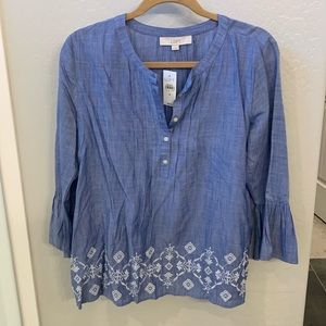 Long sleeve denim blue color blouse with white embroidery detail at the bottom